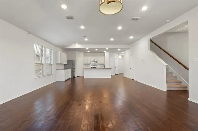 a view of an empty room and wooden floor