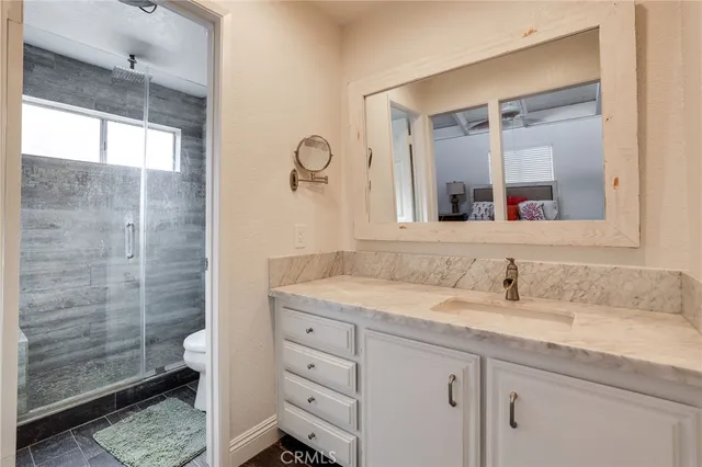 a bathroom with a granite countertop sink mirror and double