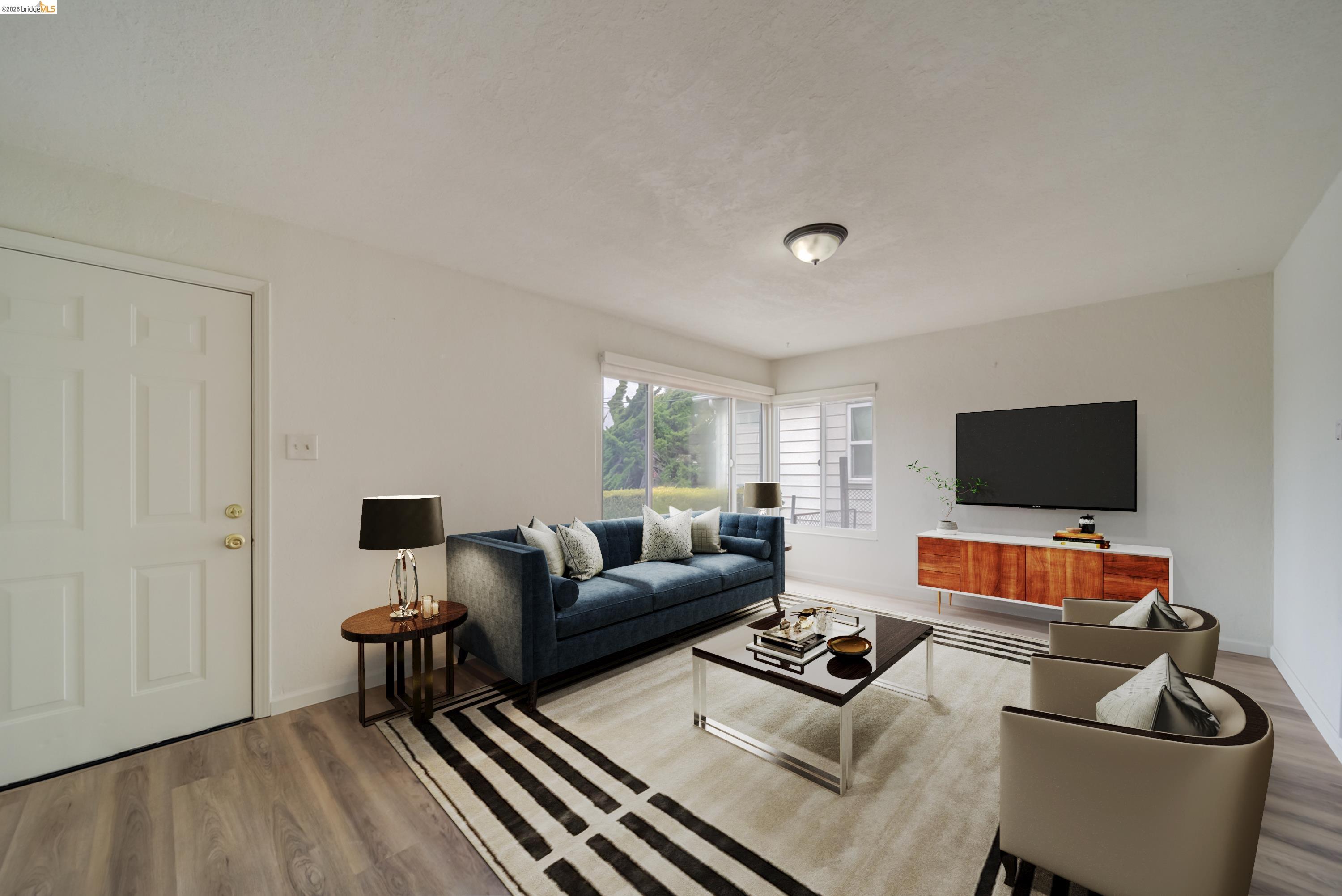 844 37th Street Richmond, CA 94805 - Photo 11 of 35 a living room with furniture and a flat screen tv