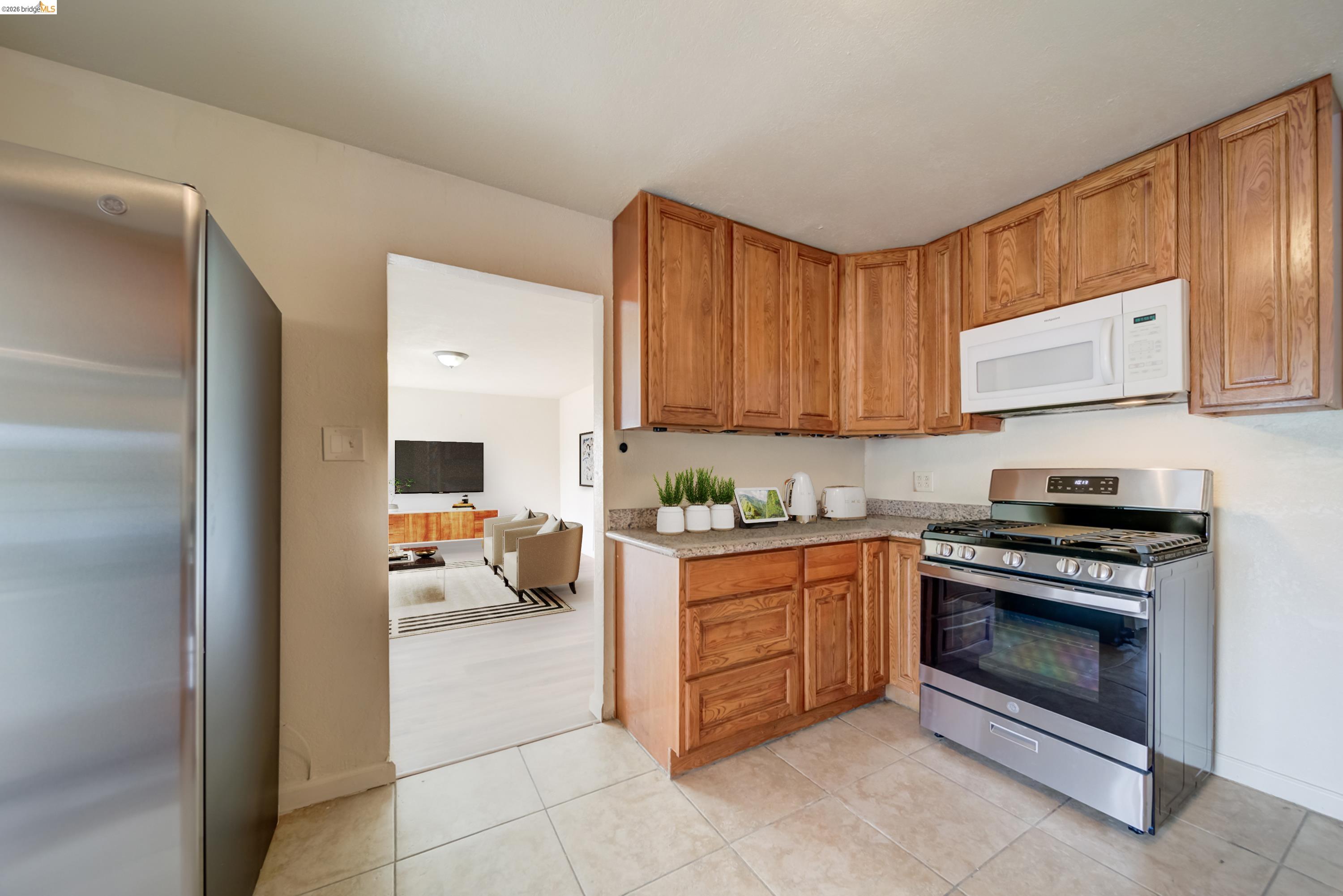 844 37th Street Richmond, CA 94805 - Photo 15 of 35 a kitchen with stainless steel appliances granite countertop a stove and a sink