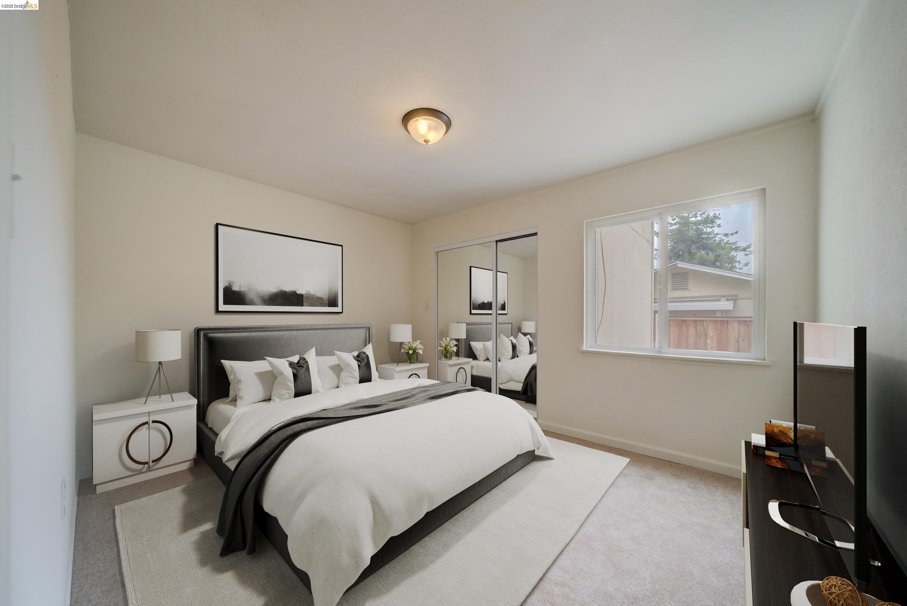844 37th Street Richmond, CA 94805 - Photo 21 of 35 a bedroom with a bed and a flat screen tv
