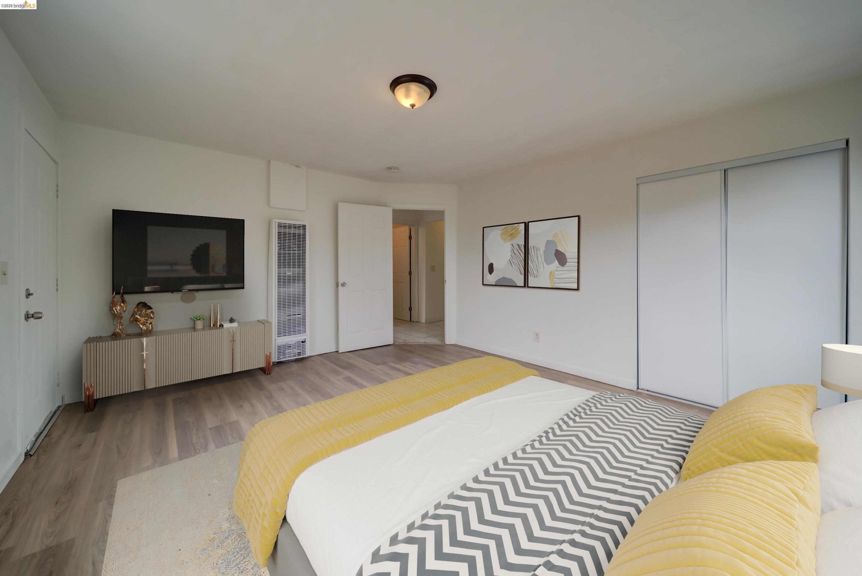 844 37th Street Richmond, CA 94805 - Photo 29 of 35 a bedroom with a bed and a flat screen tv