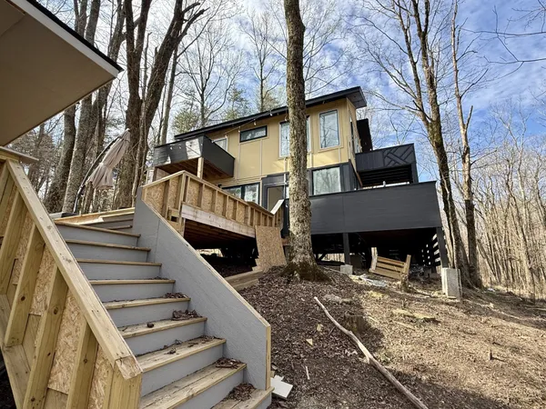 a view of a house with wooden stairs