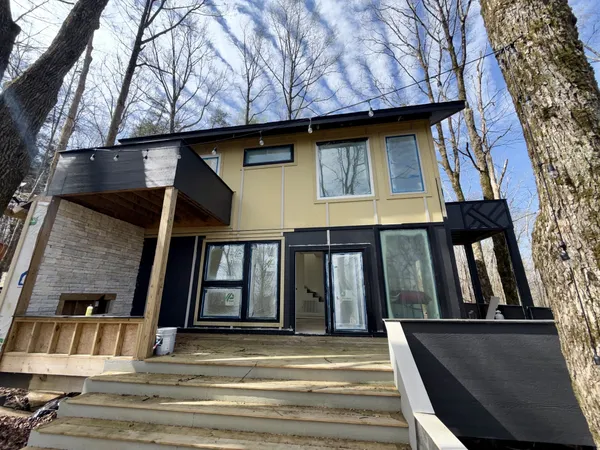 a view of outdoor space with front door and deck