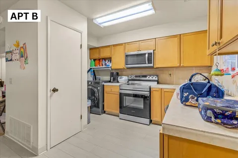 a utility room with cabinets washer and dryer