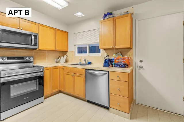 a utility room with cabinets washer and dryer