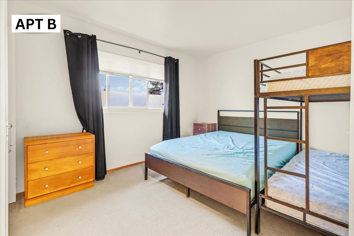 618 Forest Avenue Pacific Grove, CA 93950 - Photo 31 of 78 a bedroom with a bed and wooden floor