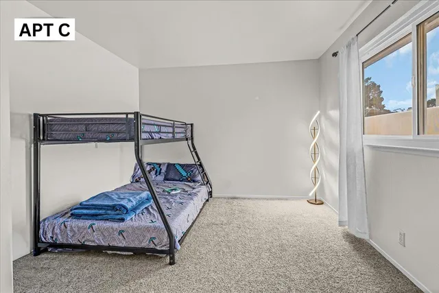 a spacious bedroom with a bed and a couch