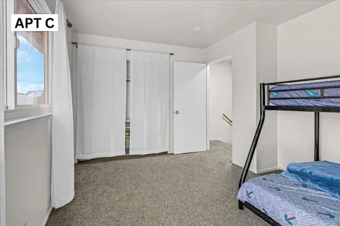 a bedroom with a bed and a desk