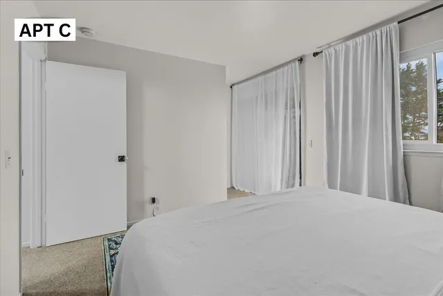 a bedroom with a bed and a desk