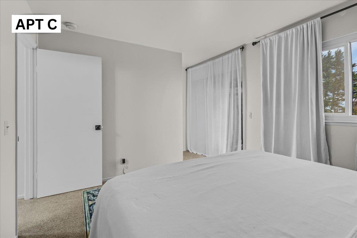 618 Forest Avenue Pacific Grove, CA 93950 - Photo 43 of 78 a bedroom with a bed and a window