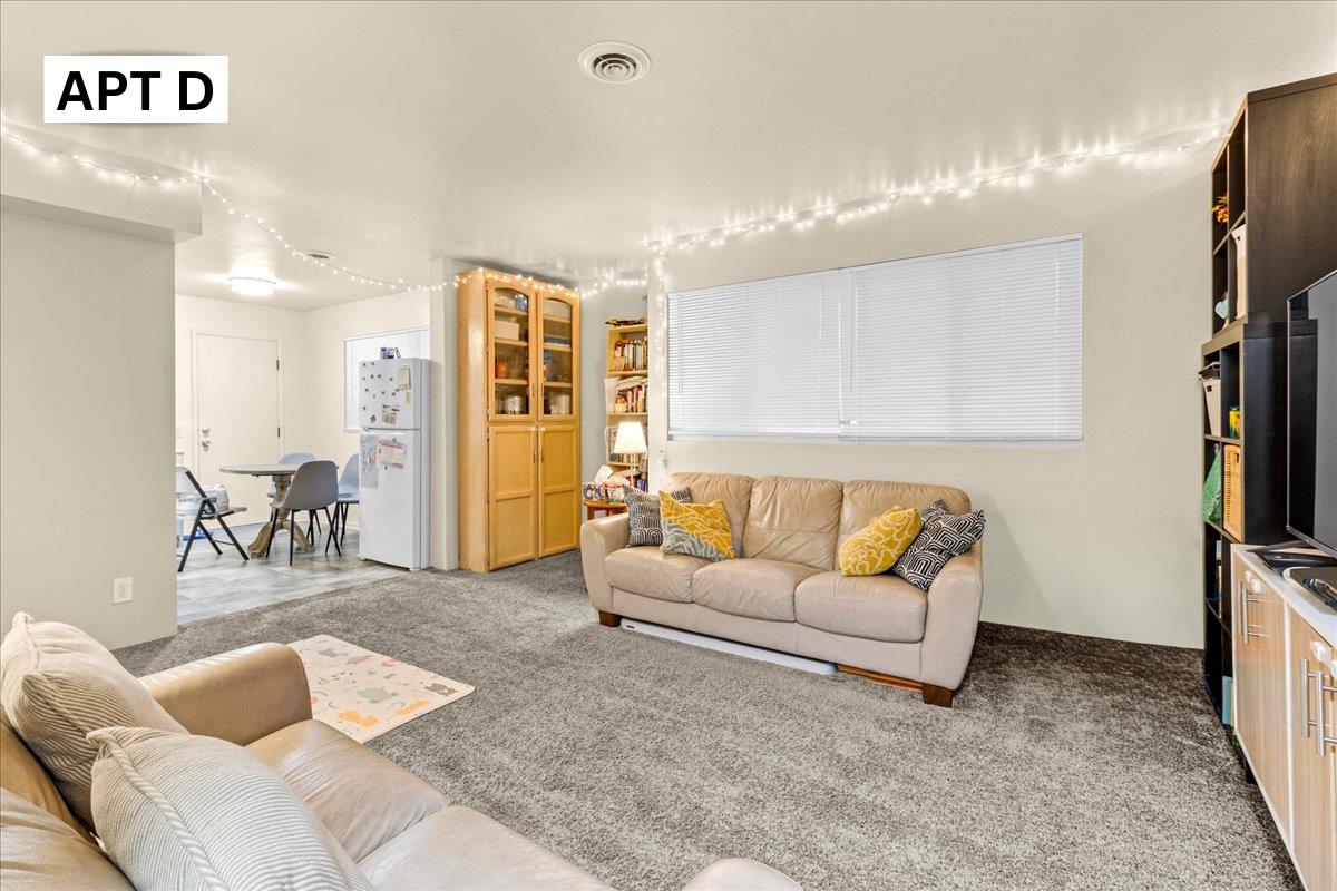 618 Forest Avenue Pacific Grove, CA 93950 - Photo 45 of 78 a living room with furniture a flat screen tv and a table