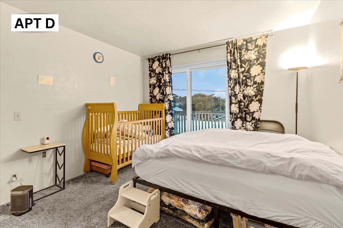 618 Forest Avenue Pacific Grove, CA 93950 - Photo 52 of 78 a bedroom with a bed and a night stand