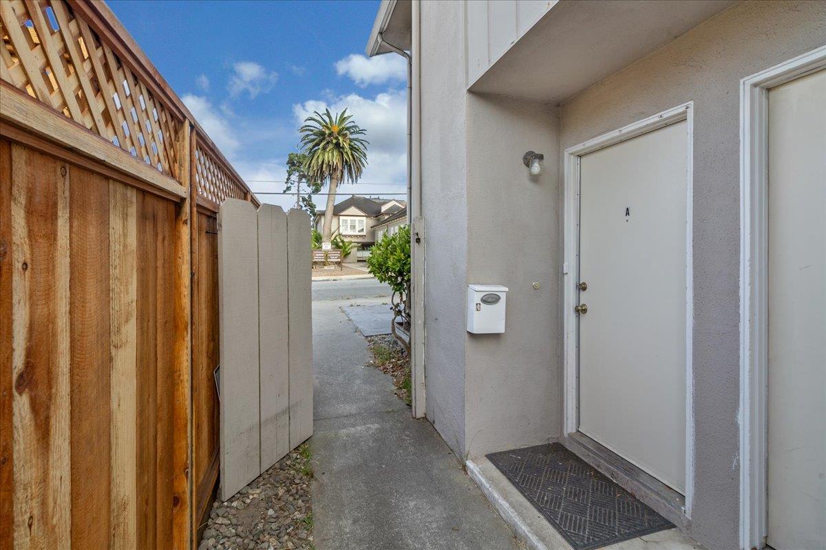 618 Forest Avenue Pacific Grove, CA 93950 - Photo 8 of 78 a view of a hallway with wooden floor and a plant