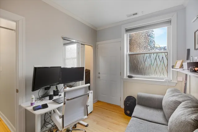 a view of a livingroom with workspace and a window