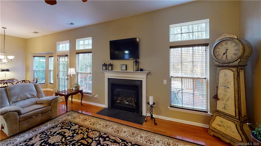 721 Warwick Way Fort Mill, SC 29708 - Photo 8 of 32 a living room with furniture a flat screen tv and a fireplace
