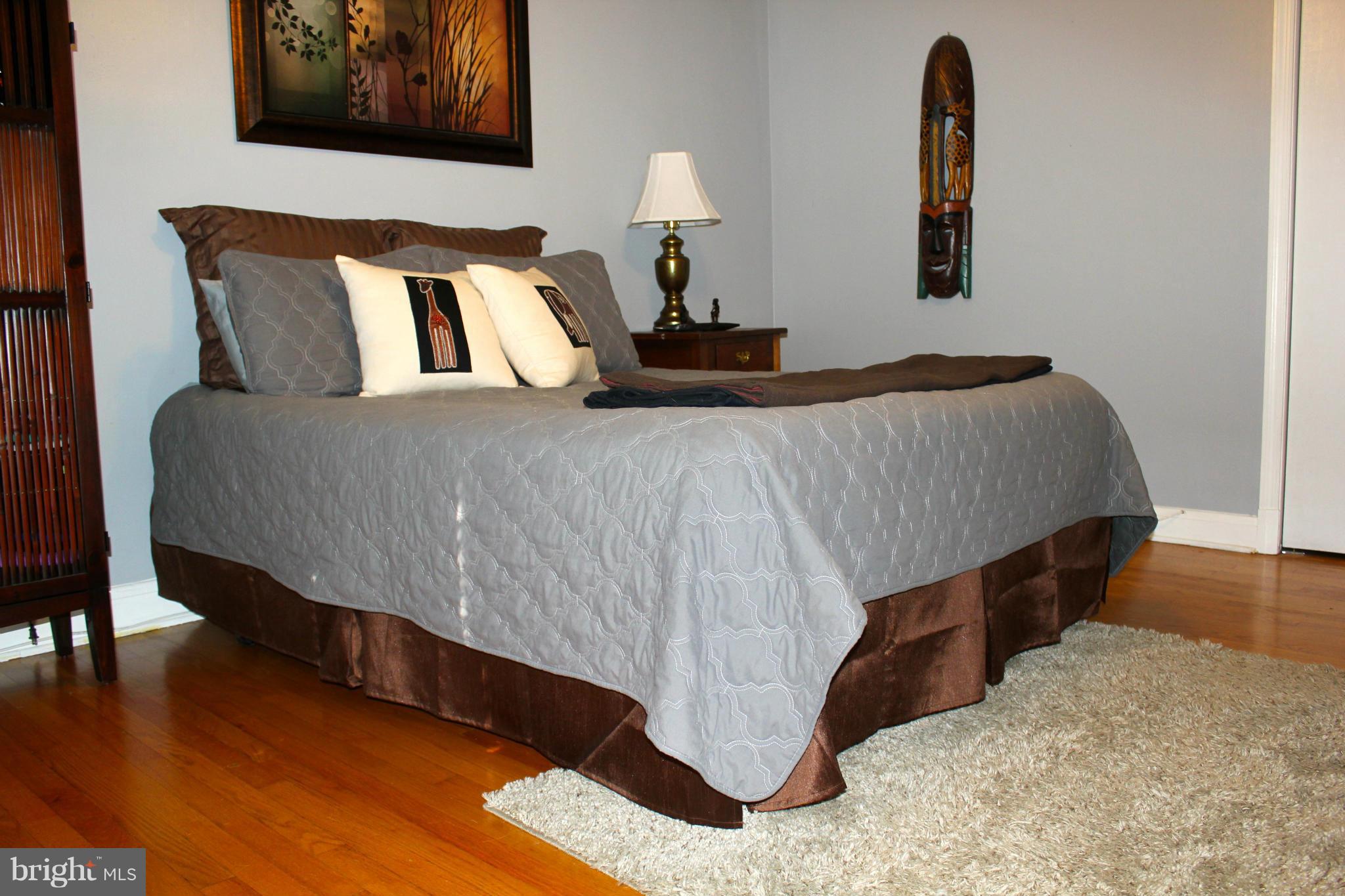 338 Dumbarton Road Baltimore, MD 21212 - Photo 15 of 30 a bedroom with a bed and wooden floor