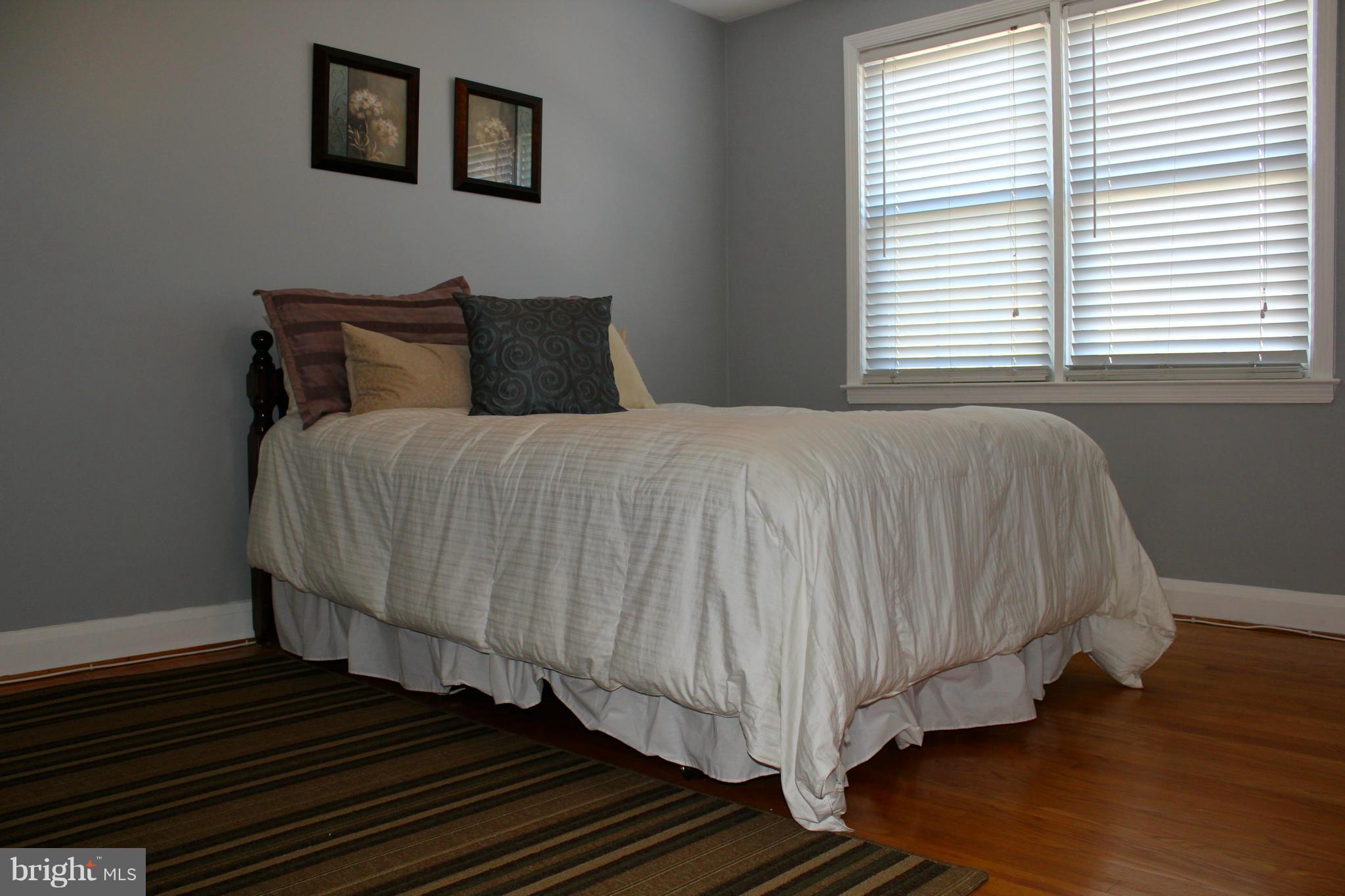 338 Dumbarton Road Baltimore, MD 21212 - Photo 16 of 30 a bedroom with a bed and wooden floor