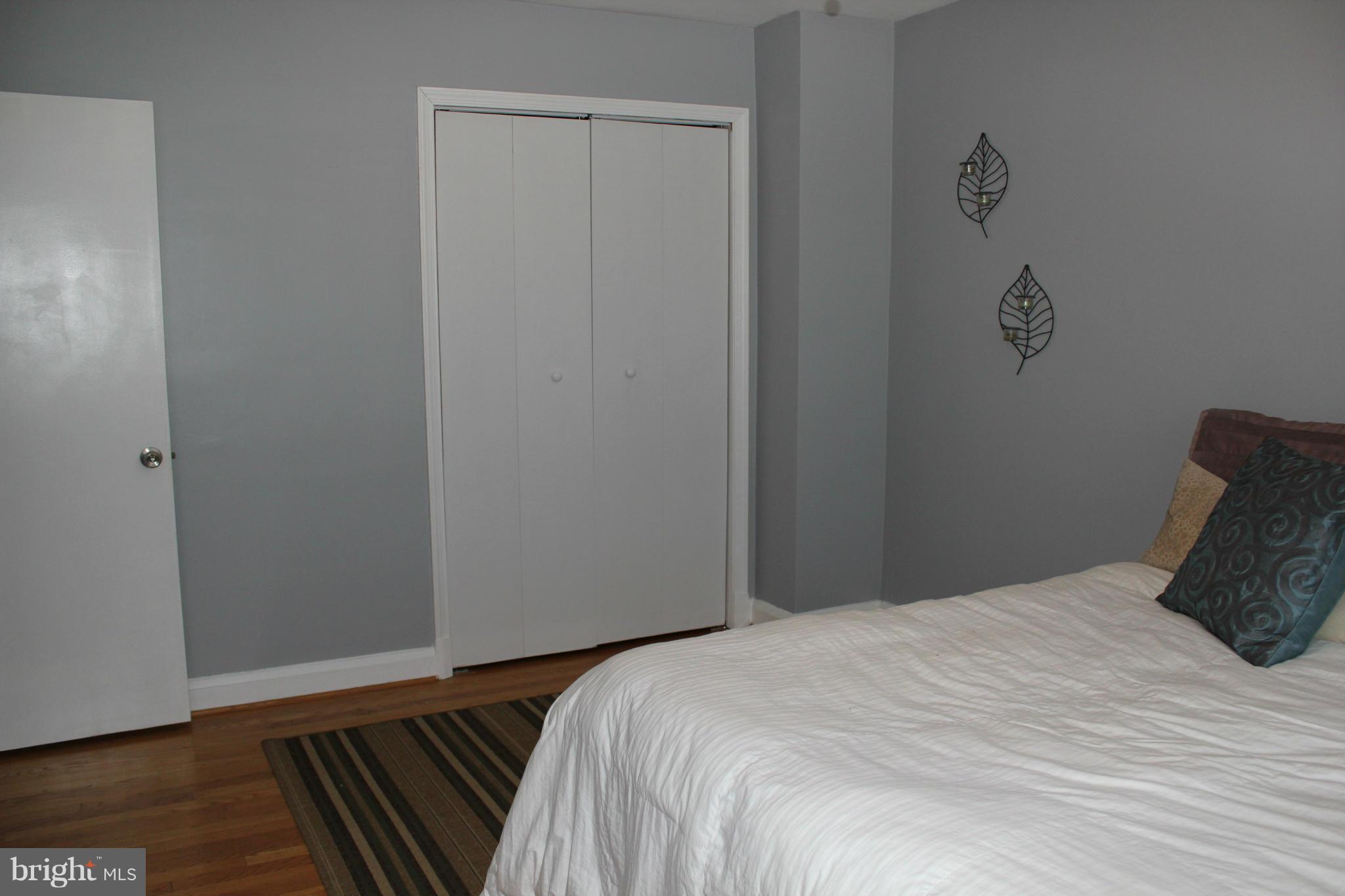 338 Dumbarton Road Baltimore, MD 21212 - Photo 17 of 30 a bedroom with a bed and wooden floor