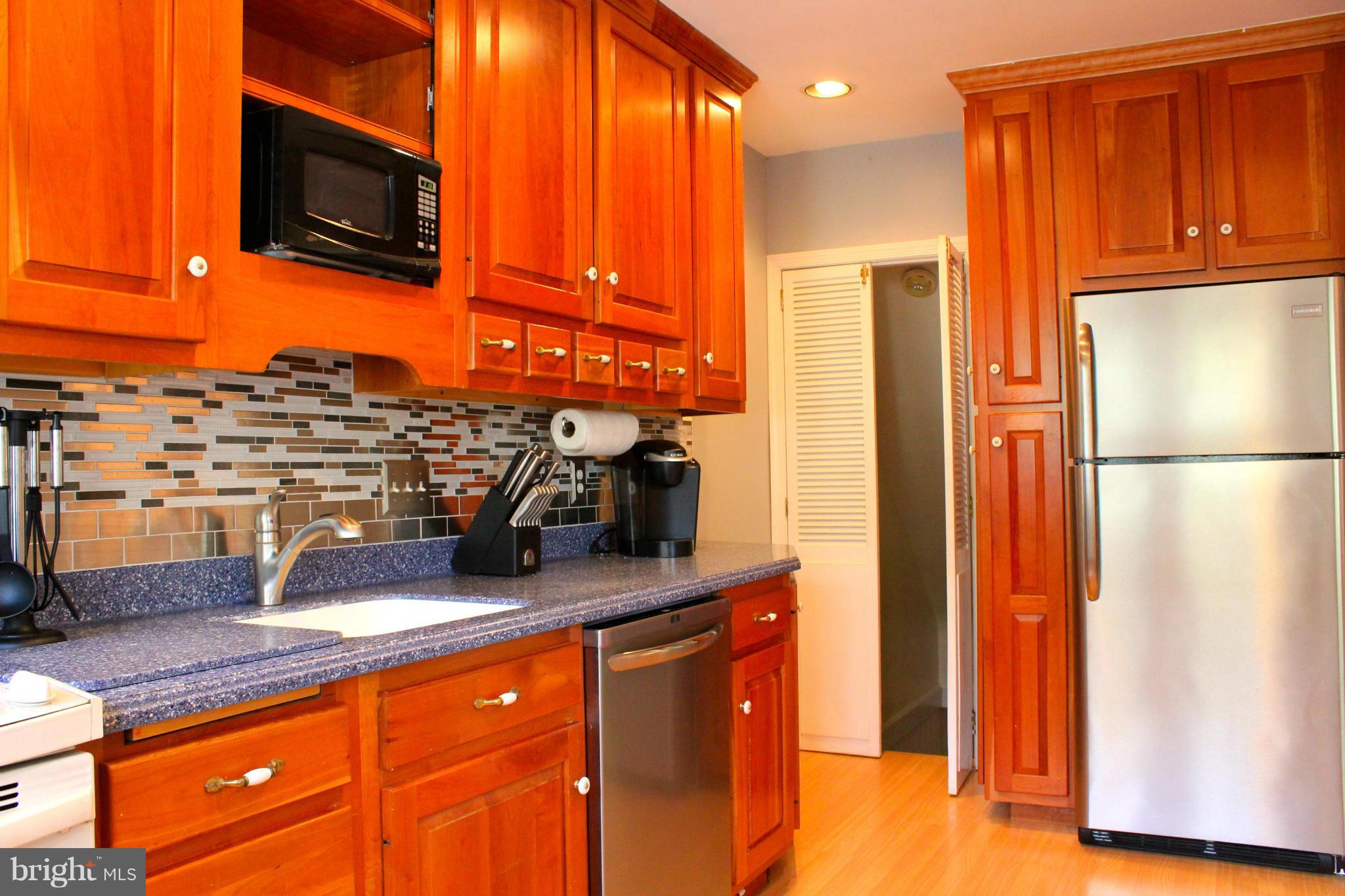 338 Dumbarton Road Baltimore, MD 21212 - Photo 9 of 30 a kitchen with stainless steel appliances granite countertop a refrigerator and a stove top oven