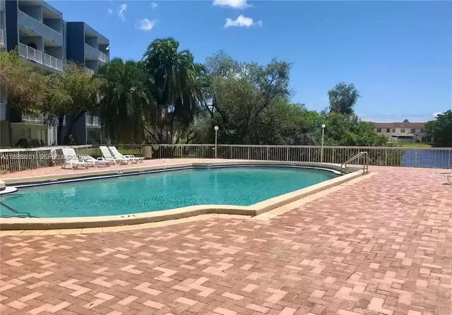 a view of a swimming pool with a yard
