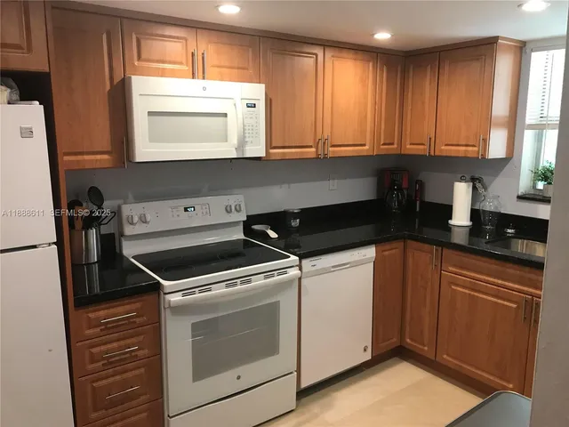 a kitchen with a stove microwave and sink