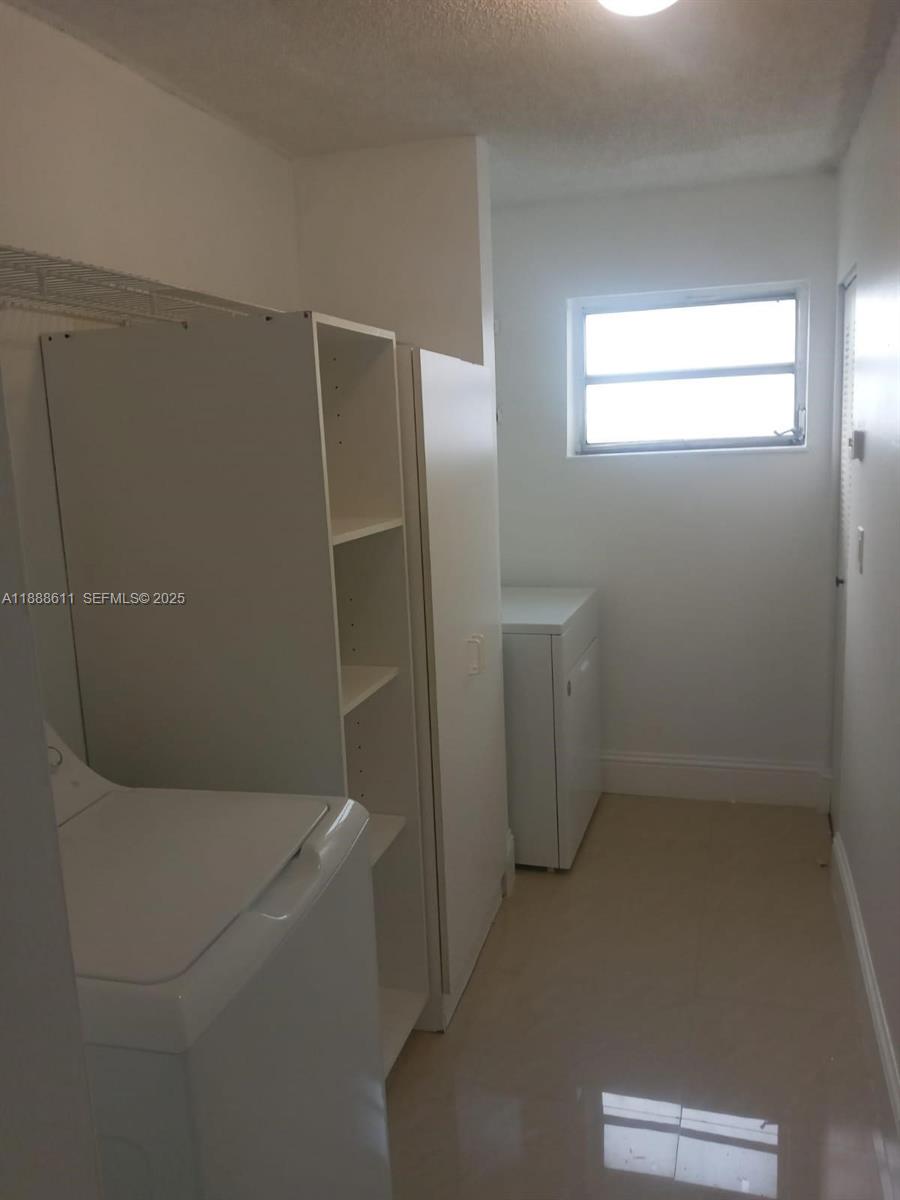 9375 Fontainebleau Boulevard, Unit L219 Miami, FL 33172 - Photo 4 of 13 a bathroom with a bathtub