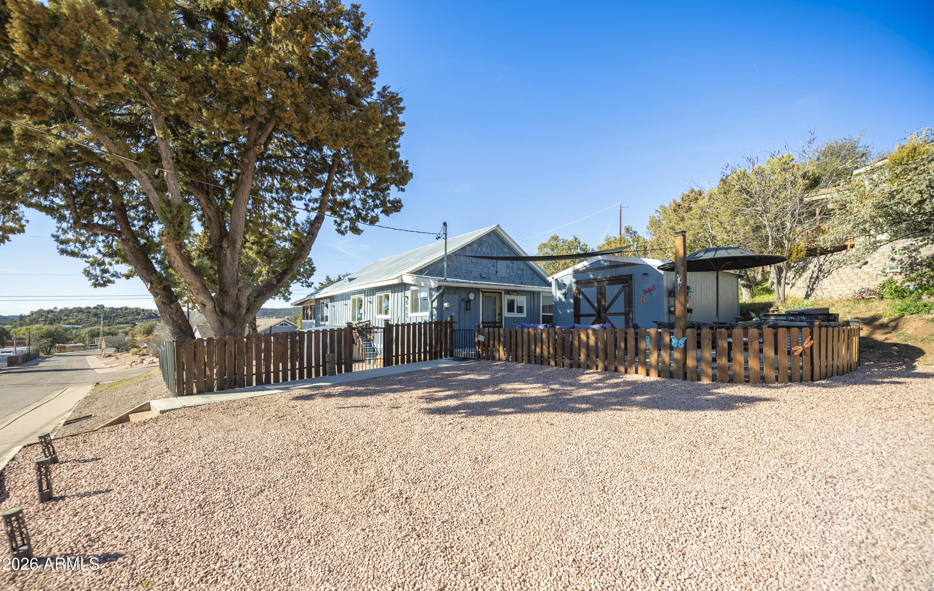 a front view of a house with a yard covered with snow