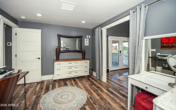 a room with furniture a flat screen tv and a dresser