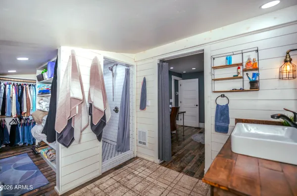 a view of walk in closet with clothes and shoes