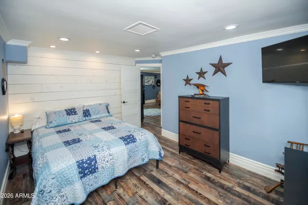 a bedroom with a bed and a television