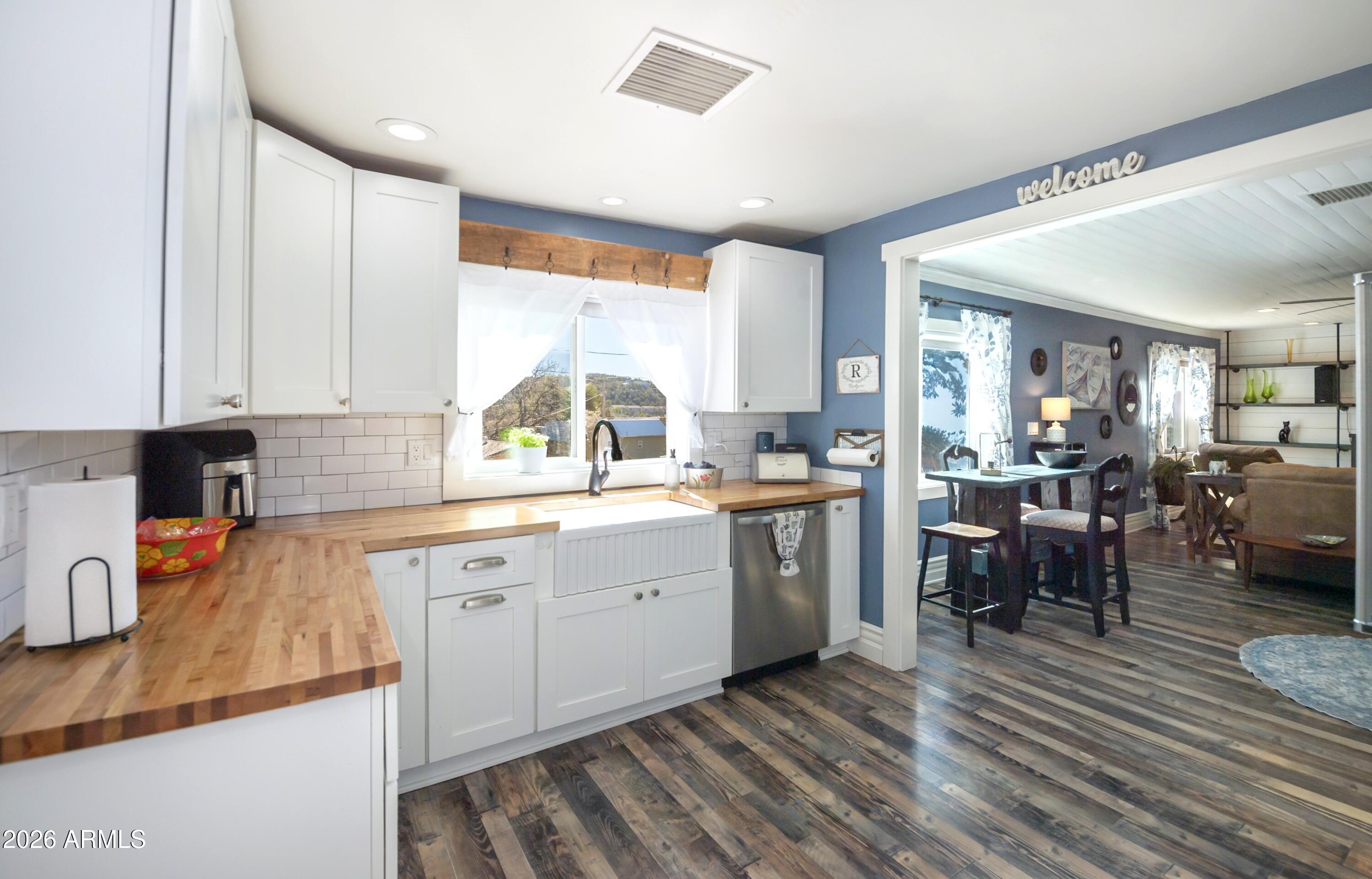 912 West Summit Street Payson, AZ 85541 - Photo 2 of 30 a kitchen with sink cabinets and wooden floor