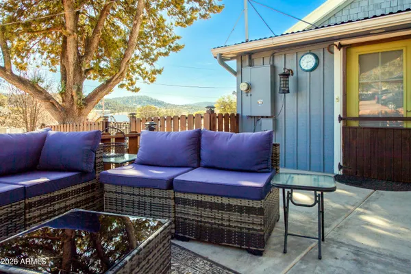 a view of a two chairs in the back yard of the house