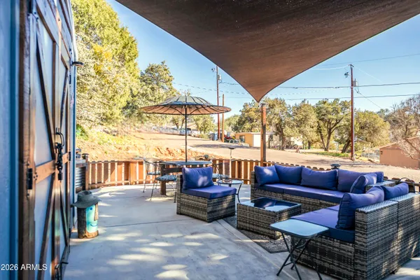 a outdoor space with patio couch and a potted plant