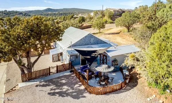 a view of a house with a yard and sitting area