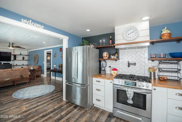 a kitchen with a refrigerator and a stove