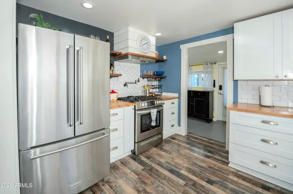 a kitchen with stainless steel appliances a refrigerator stove and sink