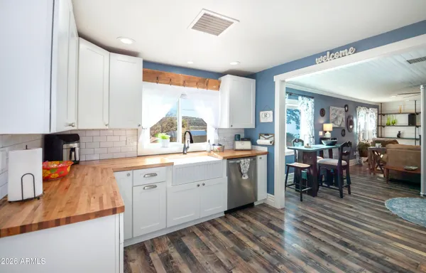 a kitchen with sink cabinets and wooden floor