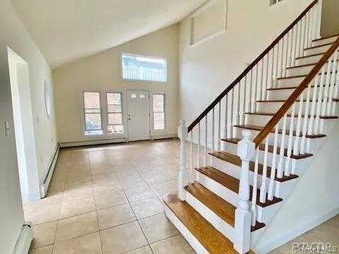 a view of entryway with stairs and wooden floor
