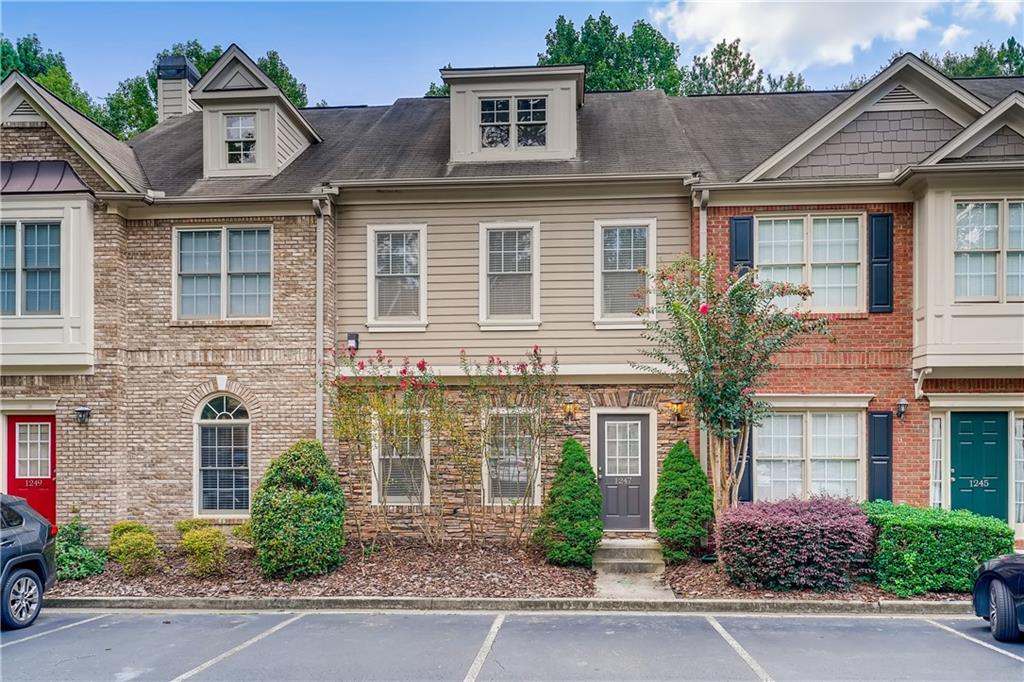 Classic townhome framed by beautiful crepe myrtles!