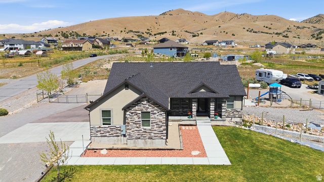 1588 West Rim Rock Drive Stockton, UT 84071 - Photo 56 of 61 Contemporary home featuring a gabled roofline, stone and stucco facade, and a covered entry