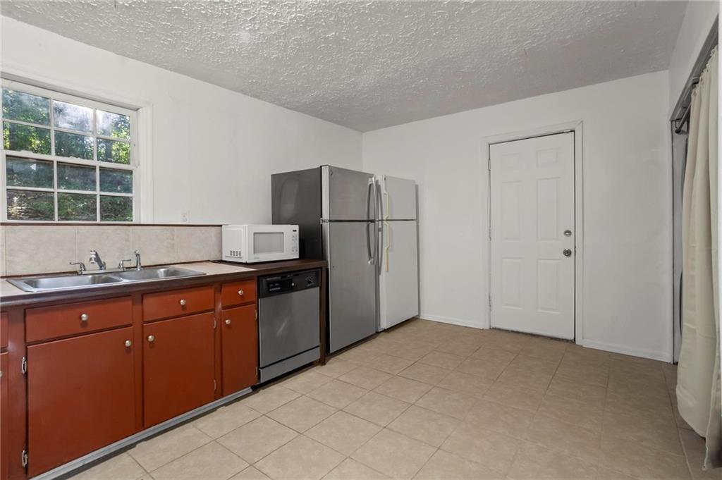 317 Argus Circle Northwest Atlanta, GA 30331 - Photo 11 of 21 a kitchen with granite countertop a refrigerator and a sink