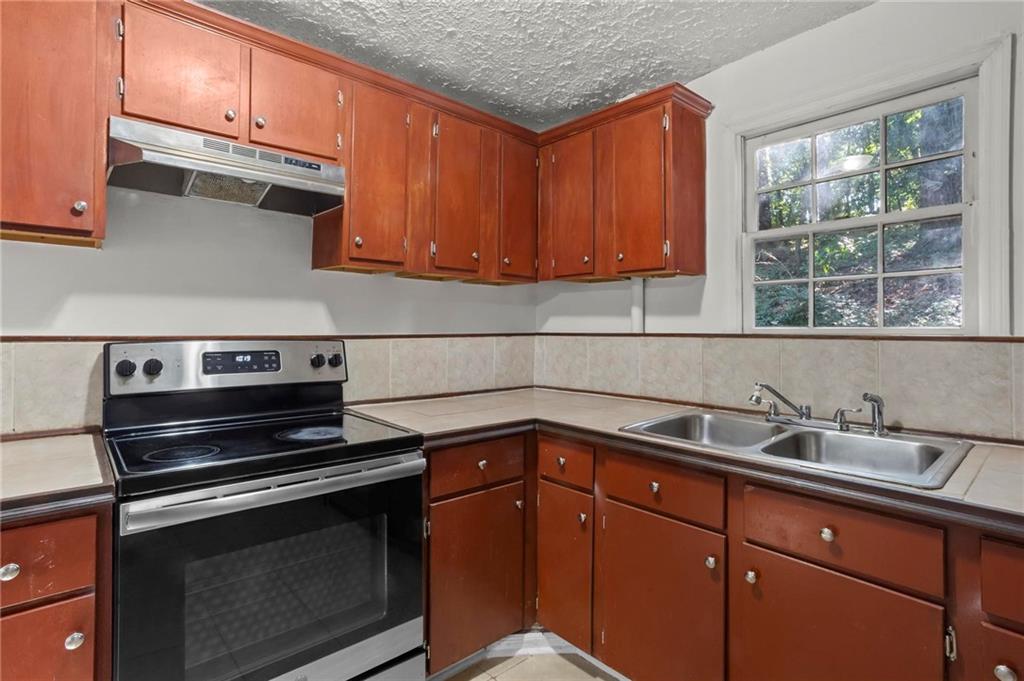 317 Argus Circle Northwest Atlanta, GA 30331 - Photo 12 of 21 a kitchen with sink cabinets and window