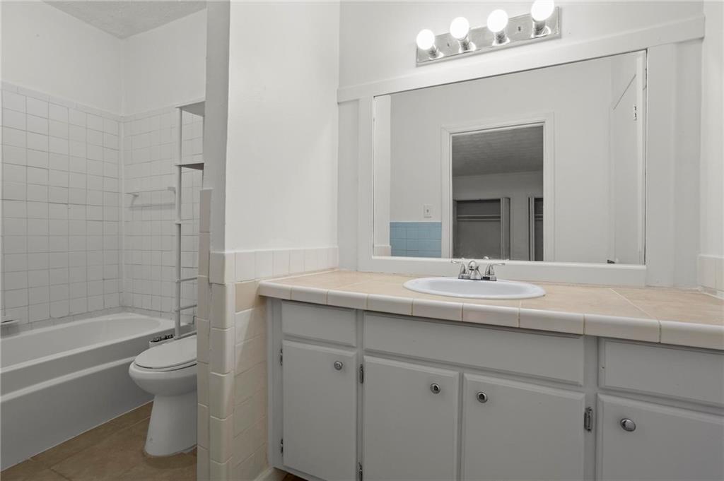 317 Argus Circle Northwest Atlanta, GA 30331 - Photo 17 of 21 a bathroom with a granite countertop sink toilet and shower