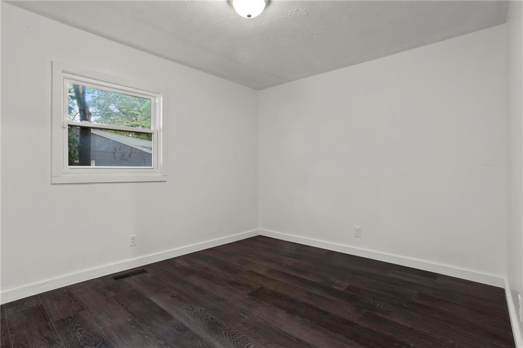 317 Argus Circle Northwest Atlanta, GA 30331 - Photo 19 of 21 a view of an empty room with wooden floor and a window