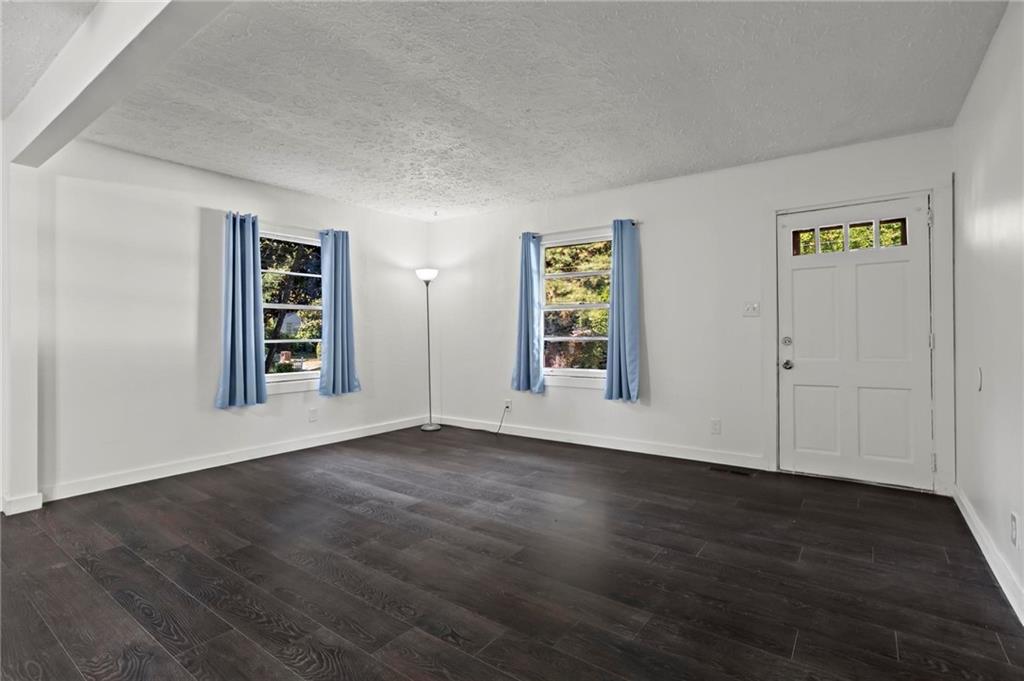317 Argus Circle Northwest Atlanta, GA 30331 - Photo 5 of 21 an empty room with wooden floor closet and windows