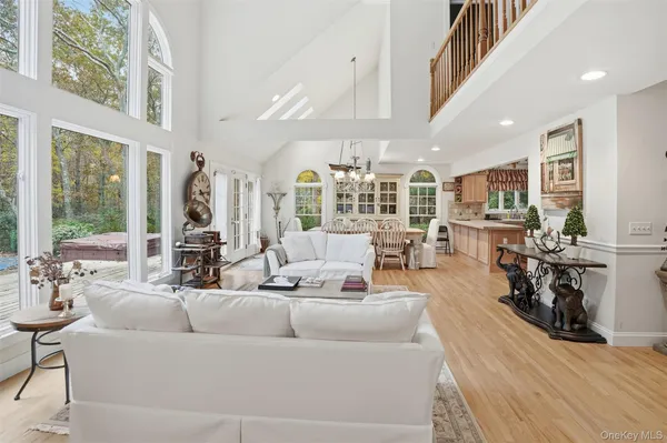 a living room with furniture wooden floor and a large window