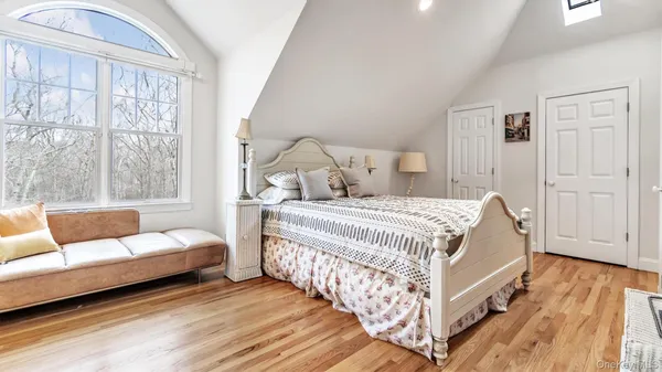 a bedroom with a bed couch and a window