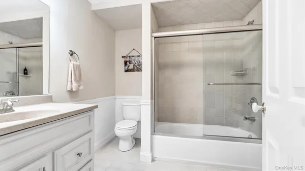 a bathroom with a sink mirror toilet and bathtub