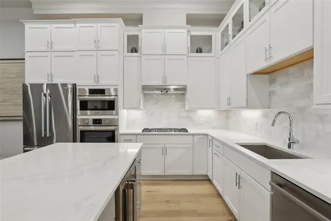 a living room with furniture kitchen and a table